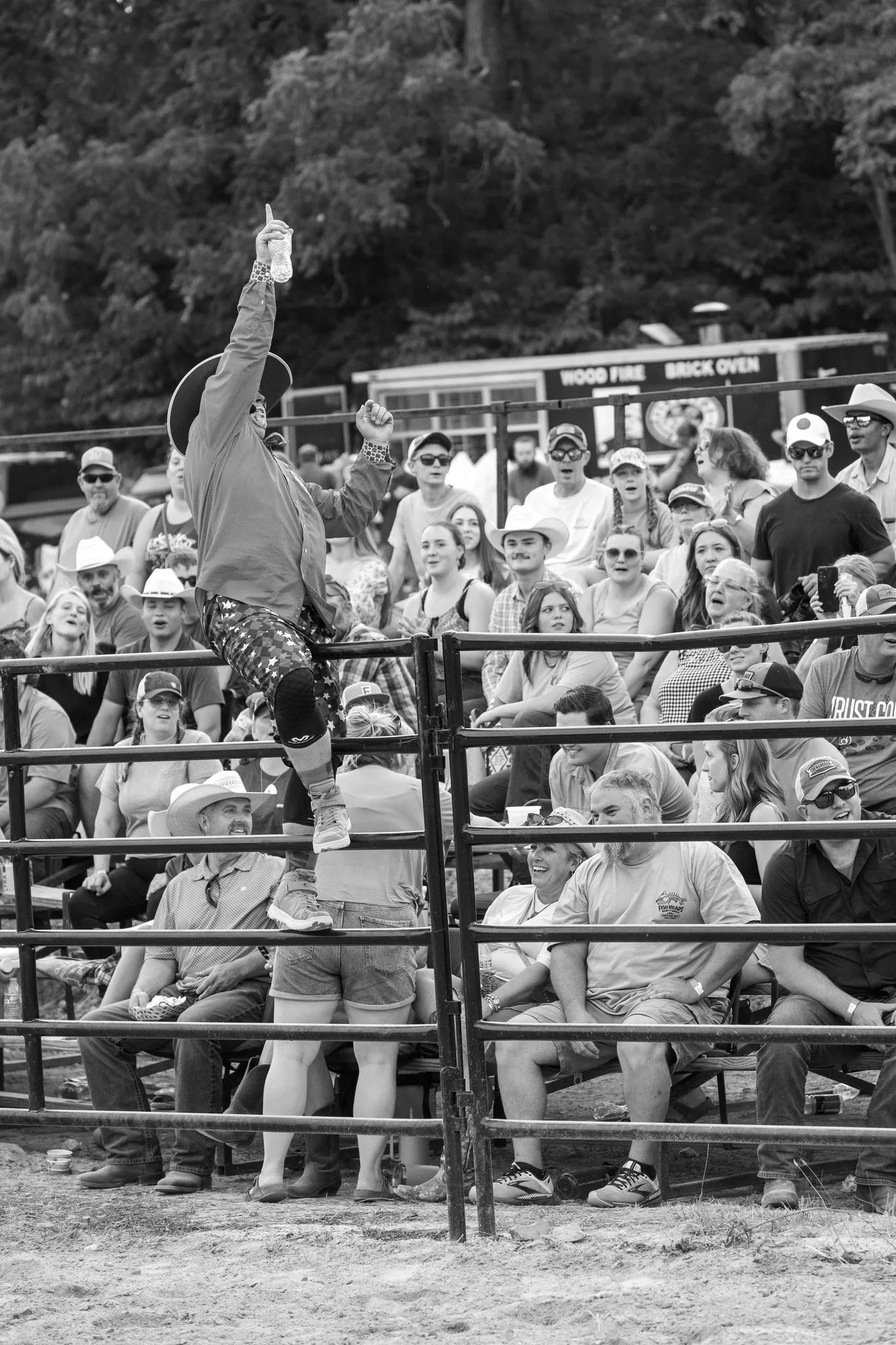 Black and white photograph of people watching the Tumbling Run rodeo
